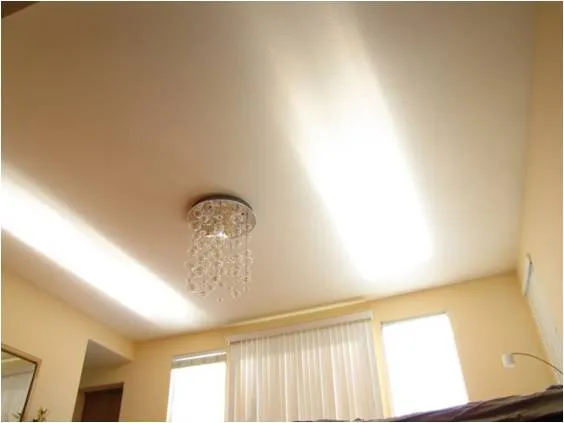 Room ceiling with bright bands of daylight cast through the windows