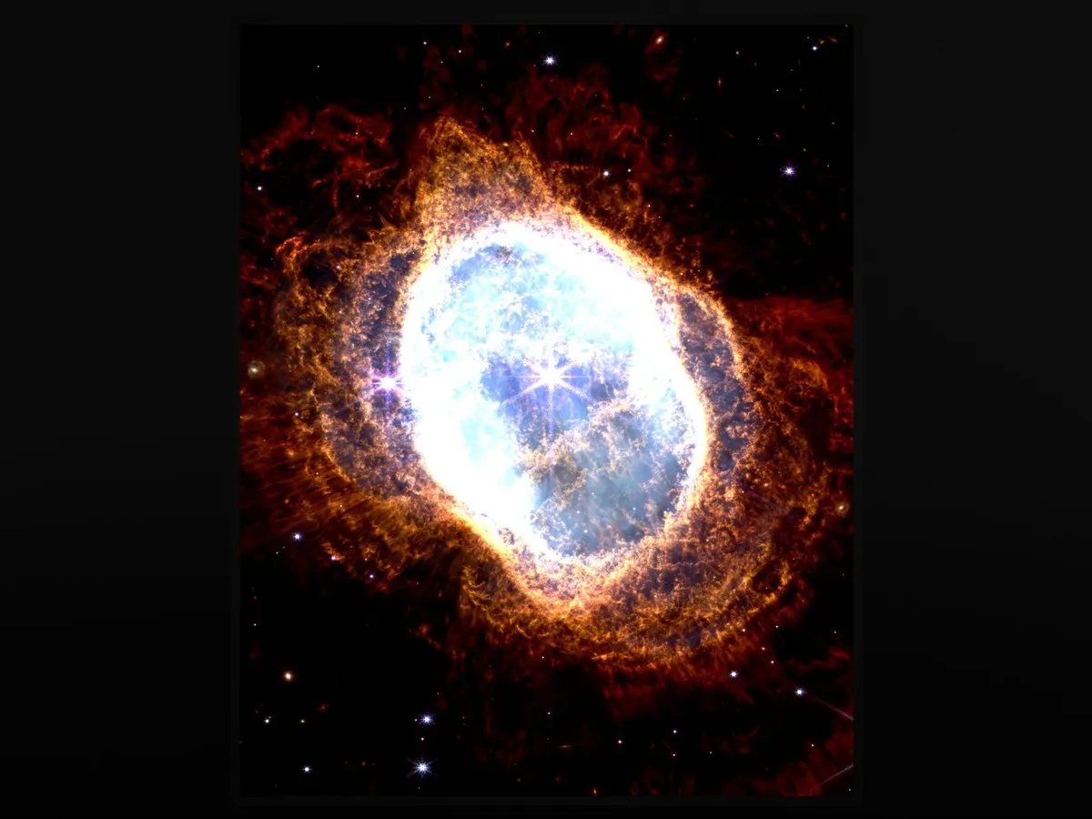 Southern Ring Nebula wall art glowing white, orange and red against a black background