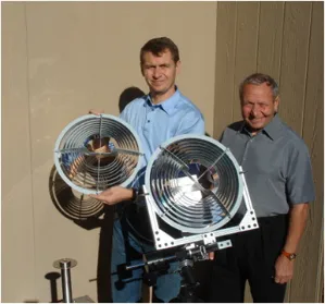 Drs. Viktor Vasylyev and Sergiy Vasylyev holding two ring-array concentrator prototypes