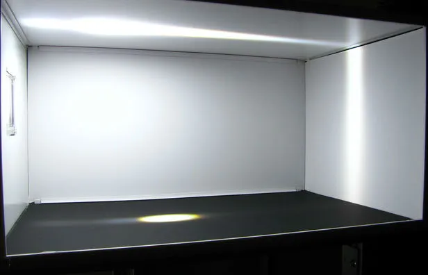 Scale-model room with daylight spread across its ceiling and walls